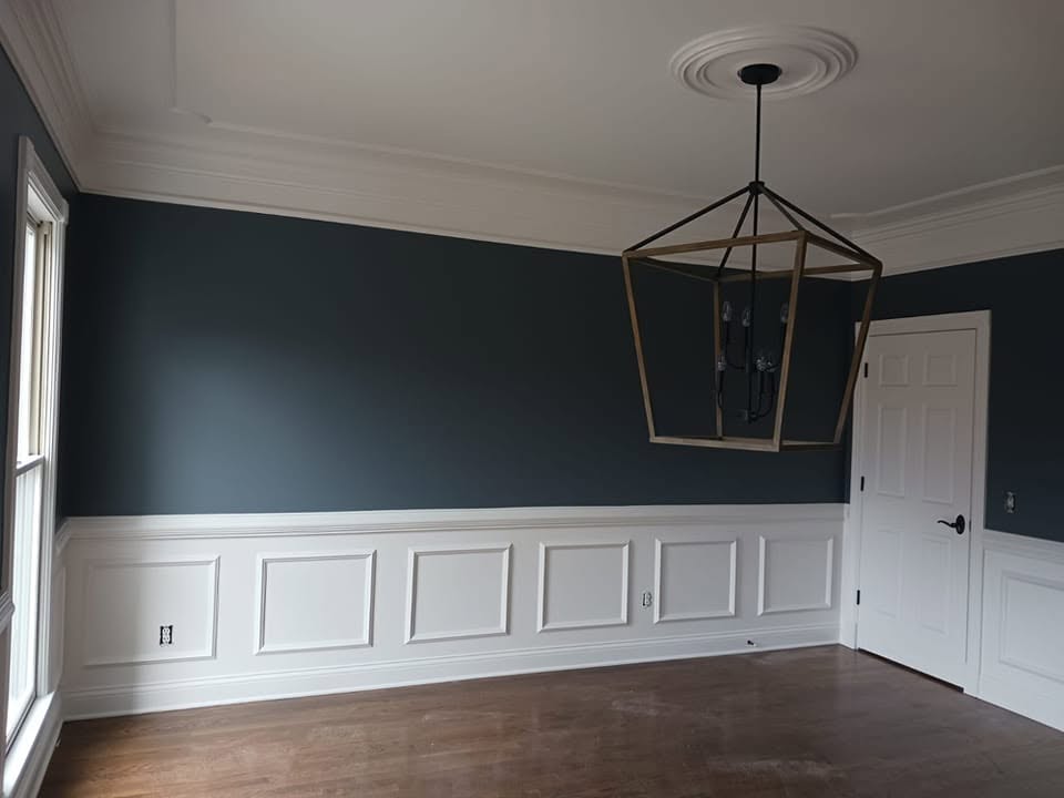 Northwest Painting and Drywall LLC project with deep green walls, white wainscoting, and a geometric pendant light