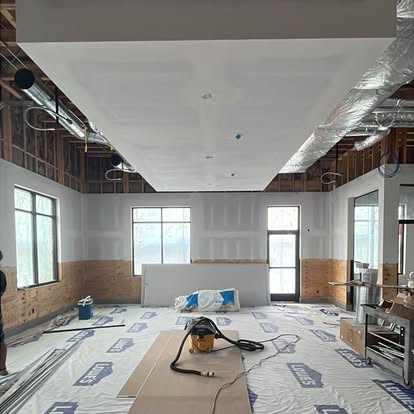 Interior project in progress with protected floors and ceiling preparation
